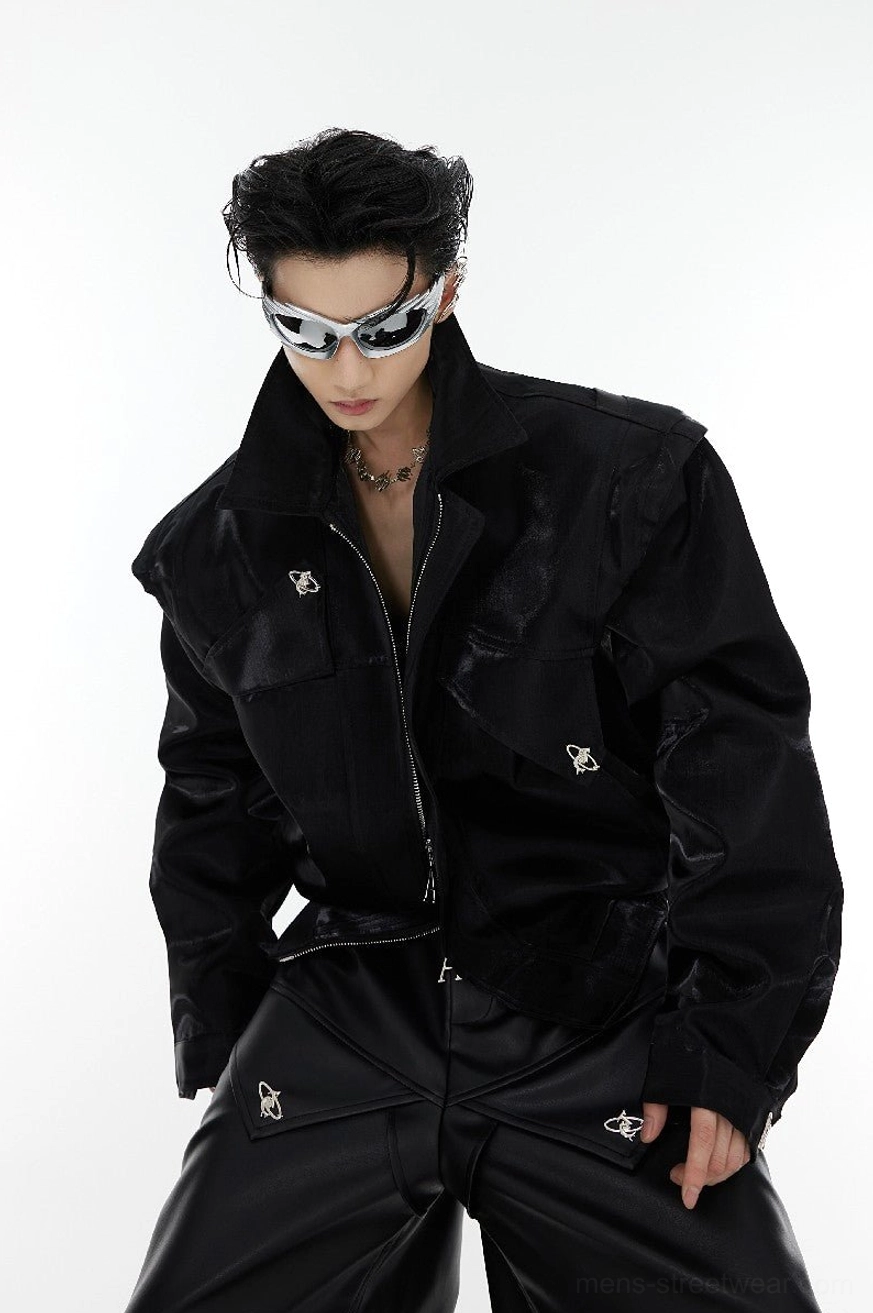 Black padded shoulder vegan leather cropped streetwear jacket front view with glossy finish, zipper closure, notched lapel and metal button details