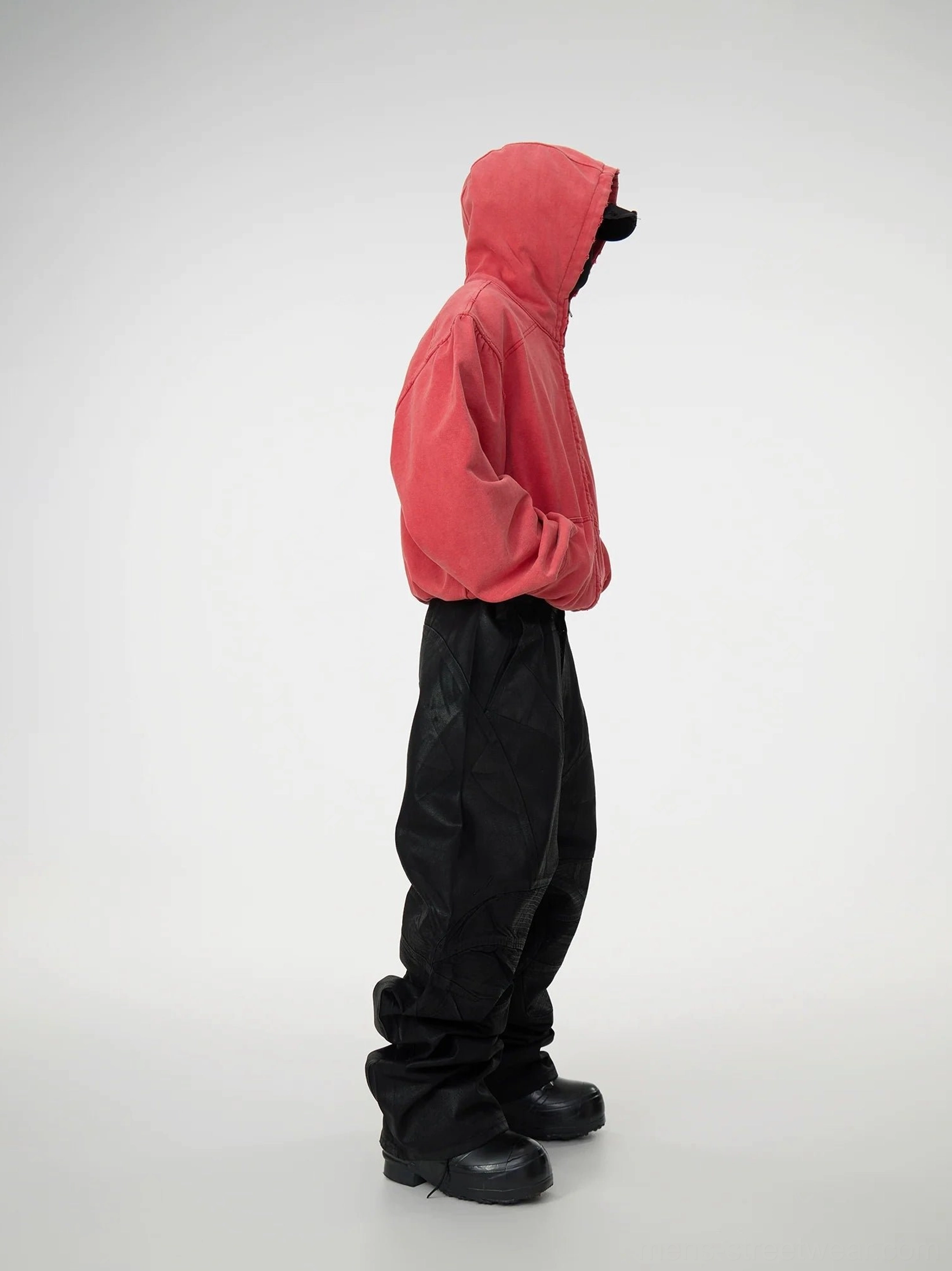 Right side view of black patchwork baggy jeans with coated denim finish, structured stitching, voluminous wide-leg silhouette, and utility-inspired streetwear outfit