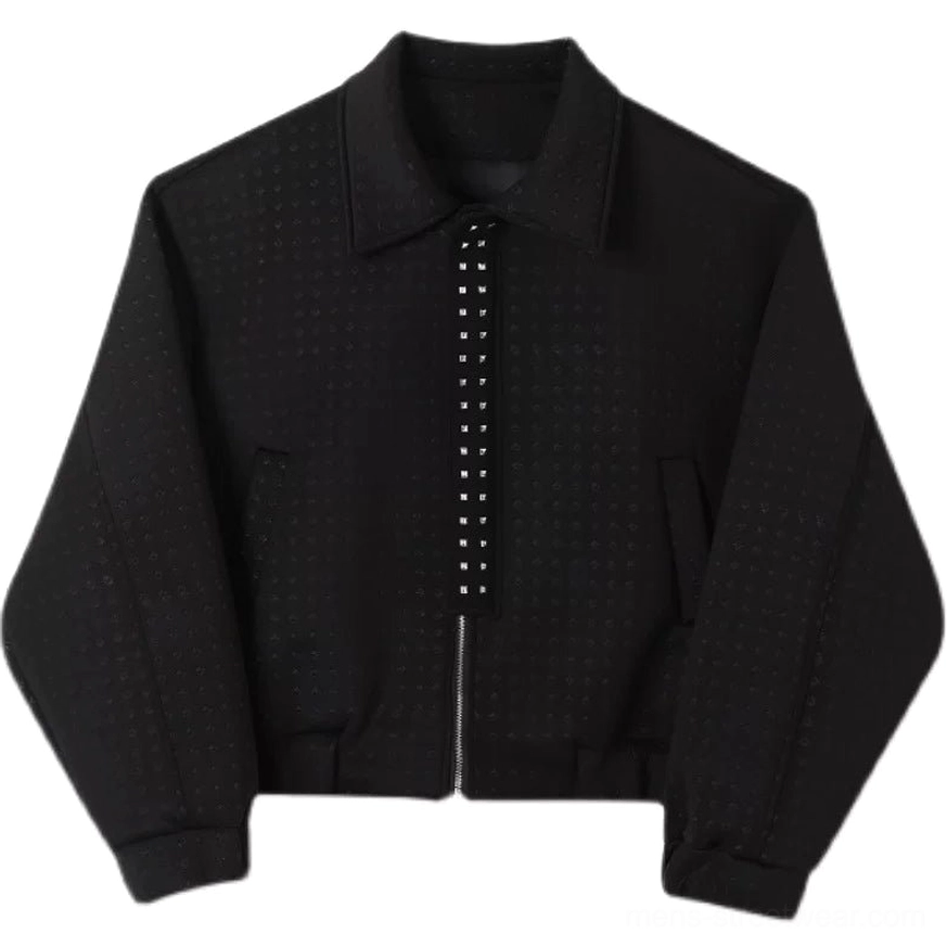 Flat lay of black perforated texture asymmetric zip techwear jacket showing cropped boxy silhouette, studded zipper, and welt pockets