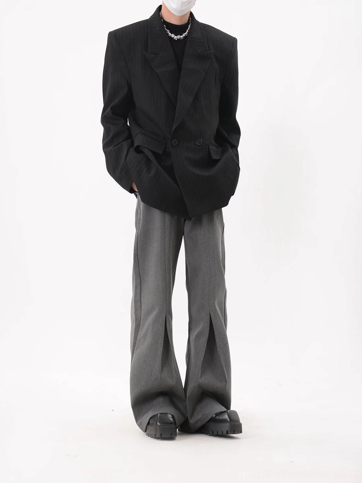 Black pinstripe double-breasted oversized blazer featuring flap pockets and relaxed modern tailoring in a streetwear outfit