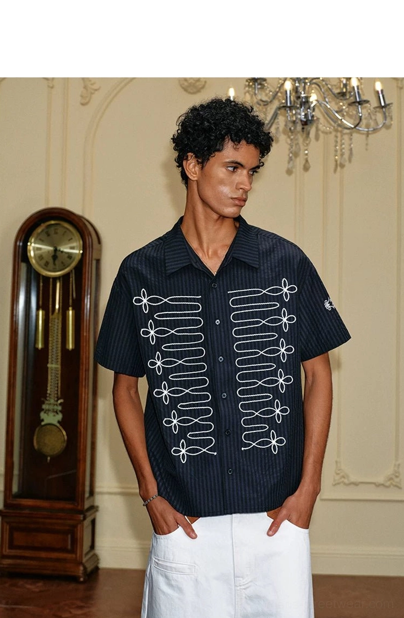 Relaxed black pinstripe short sleeve shirt with white front embroidery styled with white pants