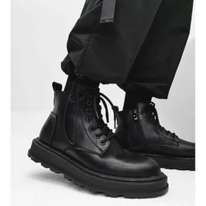 Black mid-top platform combat boots shown from a low front-side angle with smooth leather upper, chunky rubber sole, side zipper and black cargo pants for Korean streetwear styling