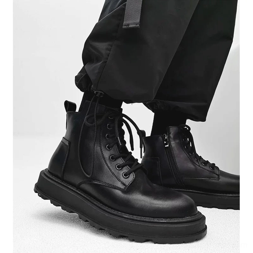 Black mid-top platform combat boots shown from a low front-side angle with smooth leather upper, chunky rubber sole, side zipper and black cargo pants for Korean streetwear styling