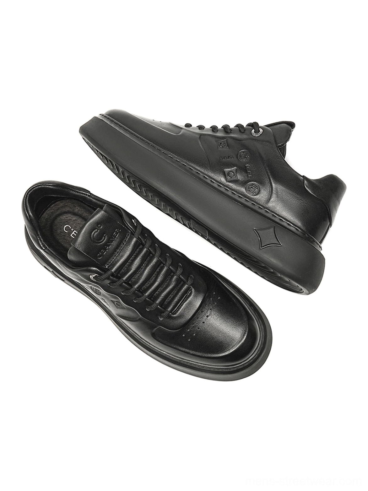 Black platform sneakers with embossed synthetic leather panels and sculpted soles for contemporary urban streetwear outfits