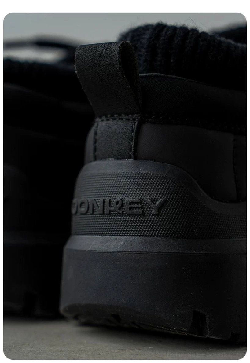 Close-up underside view of black fleece-lined platform sneakers with thick lugged rubber outsole and deep everyday traction tread