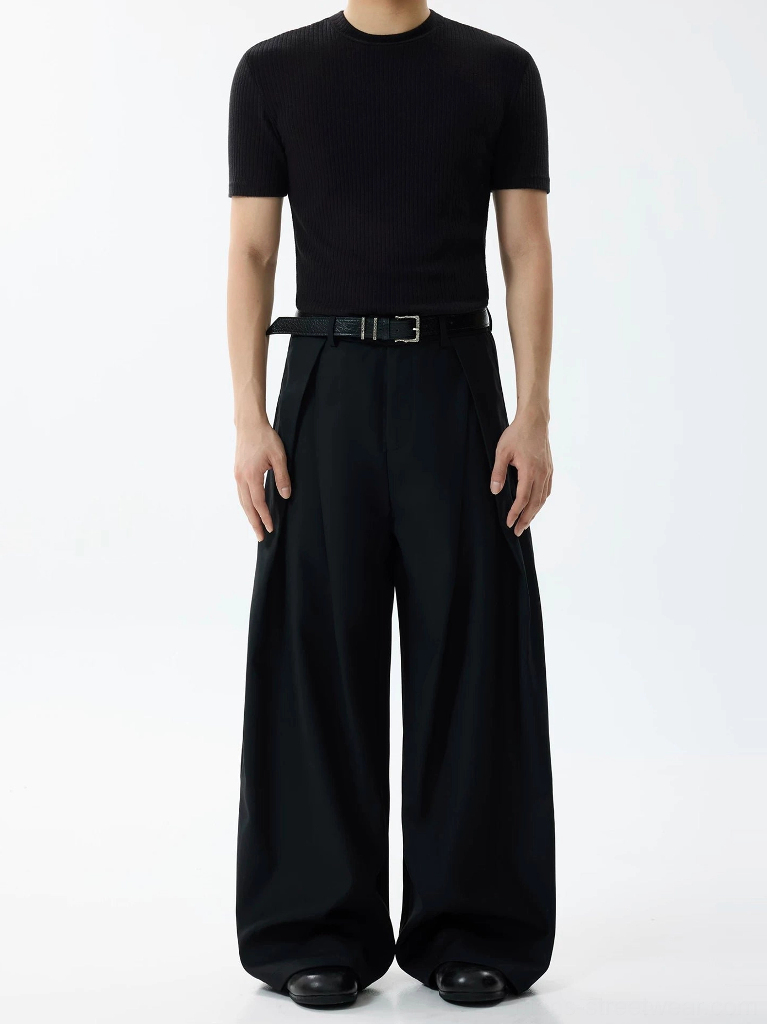 Black pleated wide-leg suit trousers with high waist, belt loops, and clean tailored silhouette
