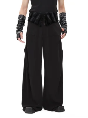 Front view of black extreme wide-leg trousers with plush faux fur waistband panel and button front detail