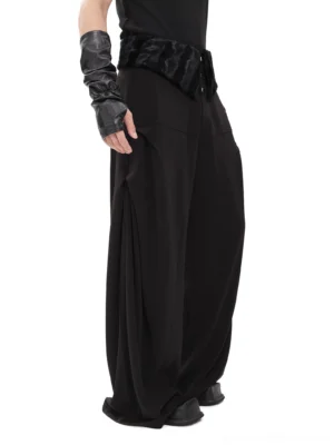 Black plush yoke wide-leg streetwear trousers shown in left side view with oversized side pocket and cropped black top