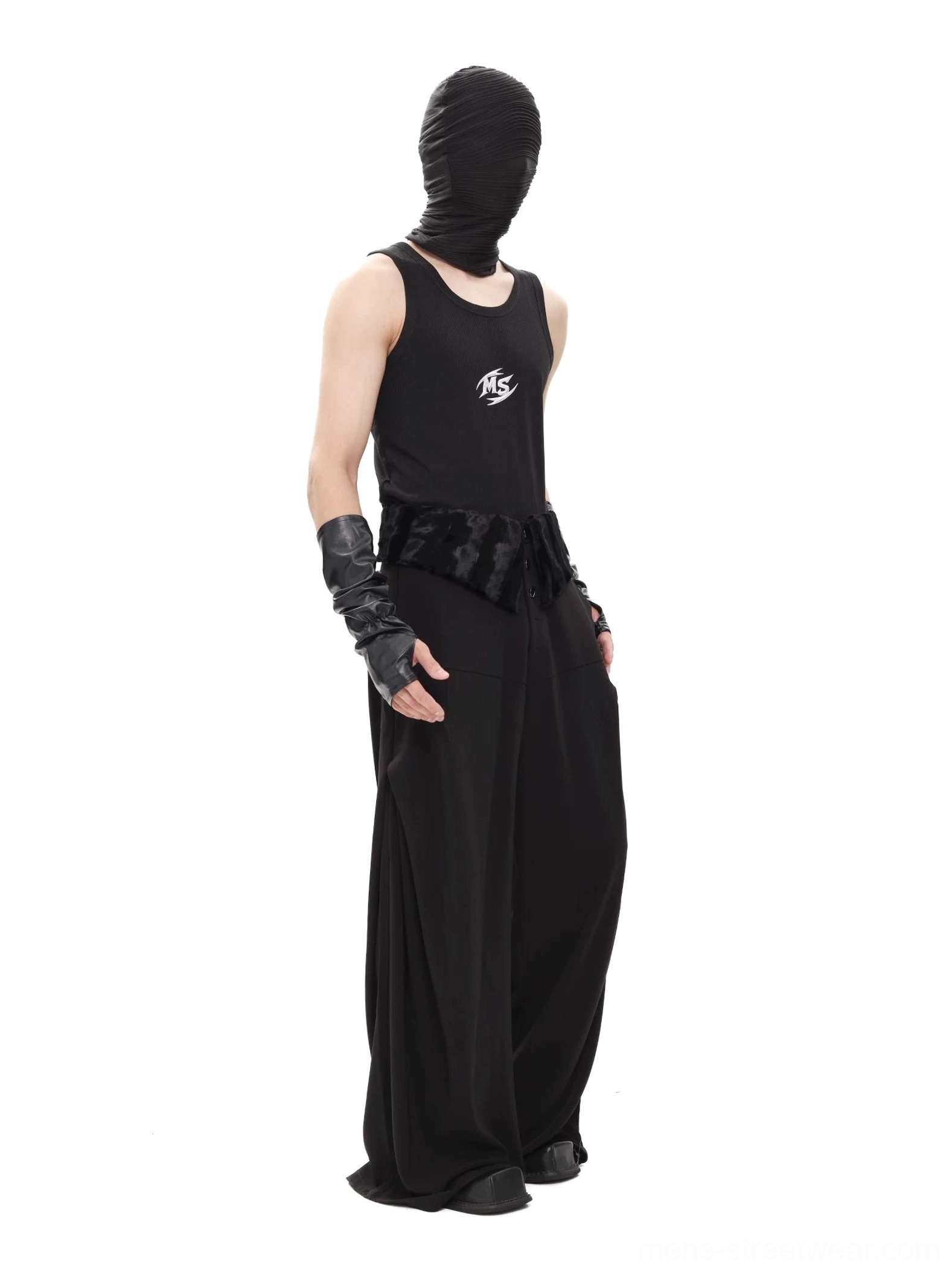 Side profile of black floor-length wide-leg trousers in an avant-garde goth streetwear outfit