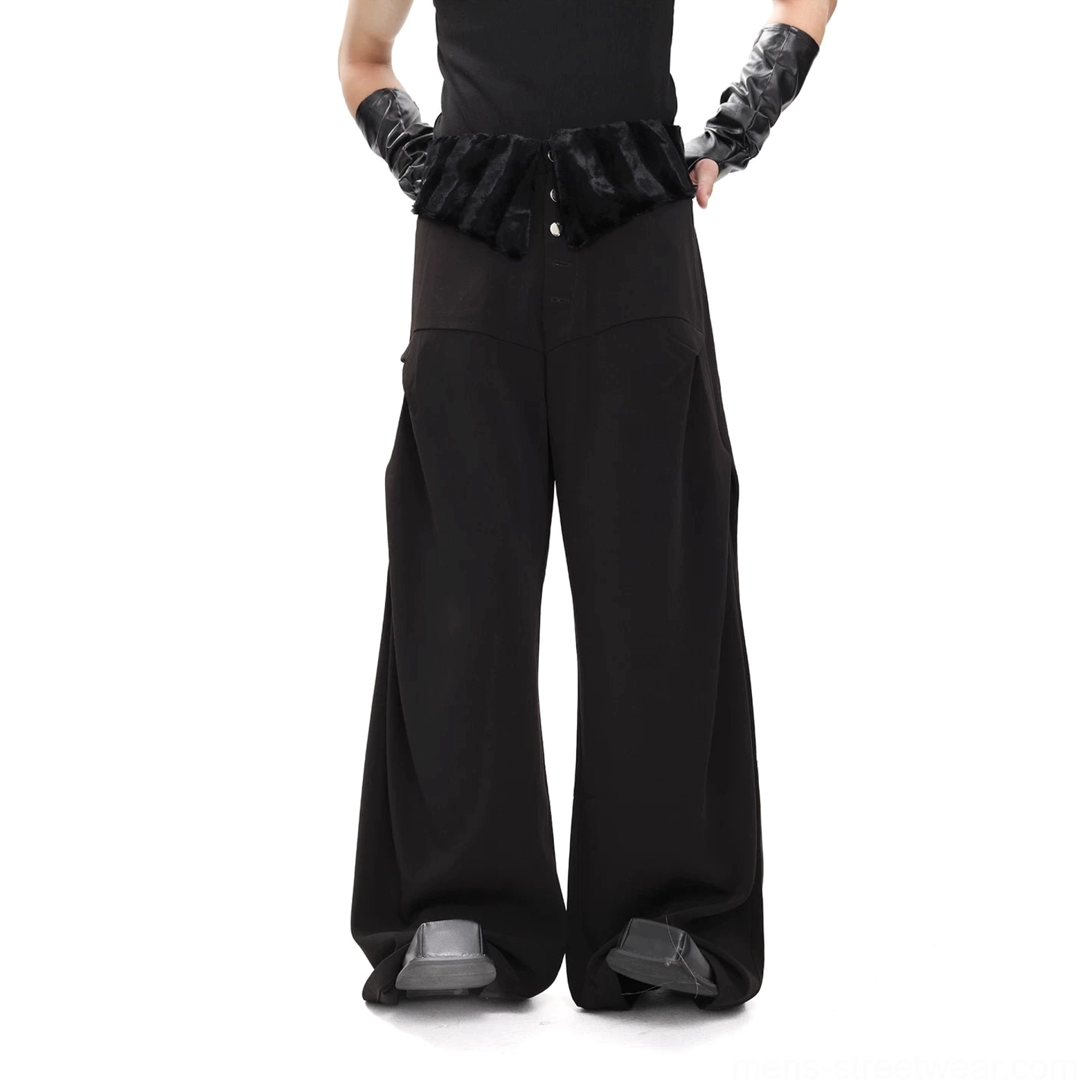Back view of black plush waistband wide-leg trousers showing relaxed oversized fit rear seam and draped legs