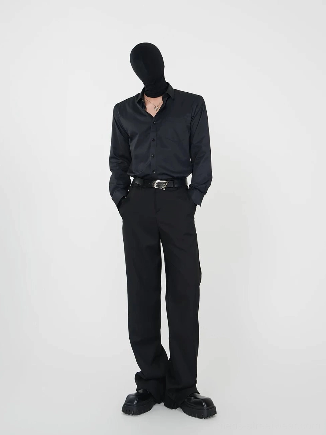 Black point-collar long-sleeve shirt styled with leather belt wide-leg trousers platform loafers and necklace