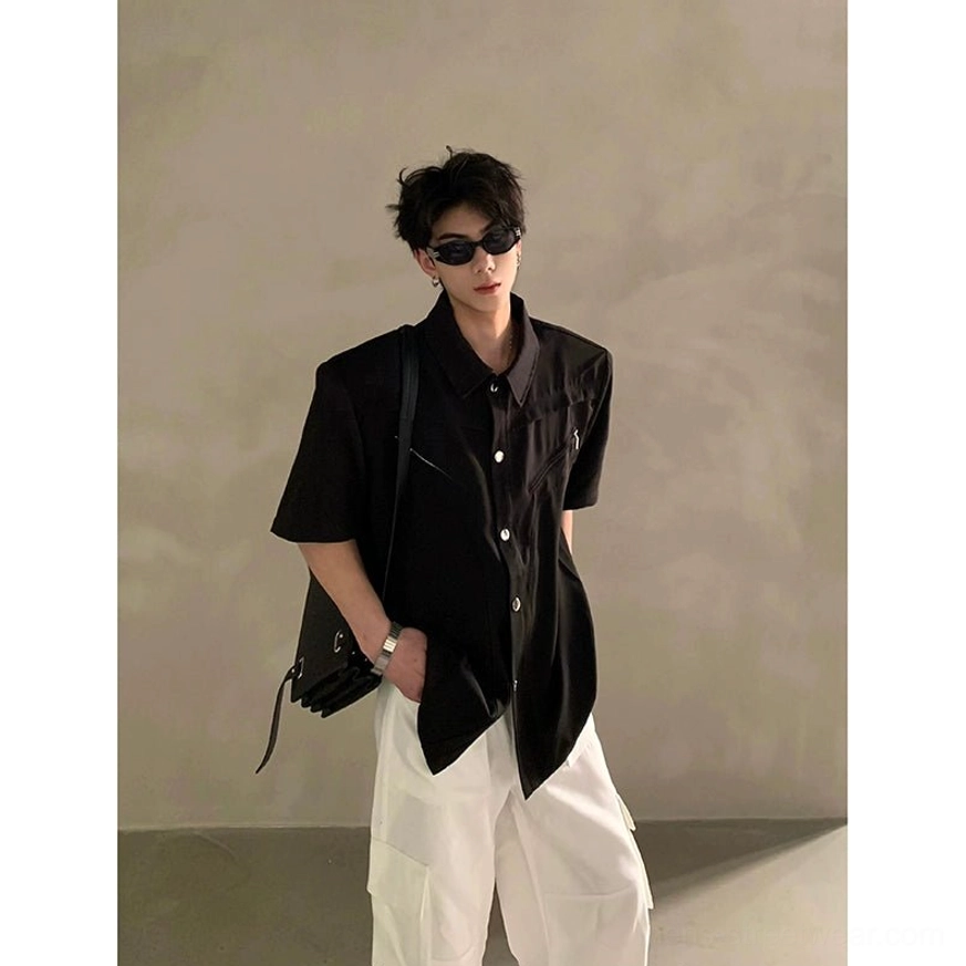 Black pointed collar short sleeve utility shirt with chest zipper accent, structured shoulders, asymmetric hem, and oversized Korean fashion fit