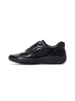 Black polished leather retro runner sneakers shown in a left side profile with glossy cowhide upper mesh panels and sculpted streetwear outsole
