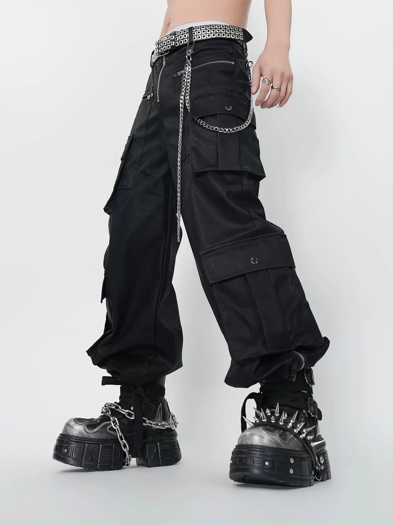 Streetwear outfit featuring black punk platform boots with cargo pants chain belt and industrial hardware styling