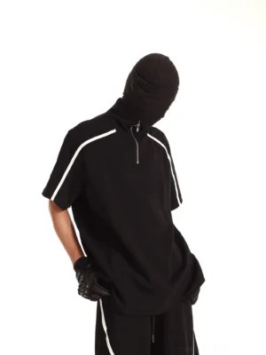 Black quarter-zip mock neck track tee with white shoulder piping shown in a left three-quarter streetwear view