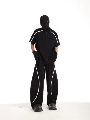 Black quarter-zip track tee and matching wide-leg pants set with white piping in an oversized Korean streetwear outfit