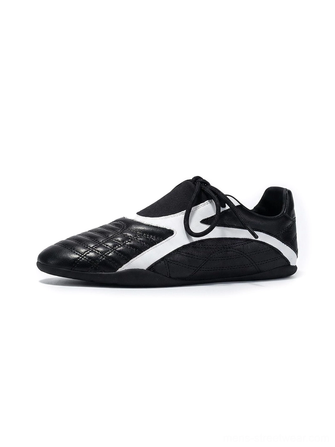 Black quilted panel flat-sole sneakers shown from the left side with white contrast inserts, black flat laces, and a low-profile rubber sole on a clean white background