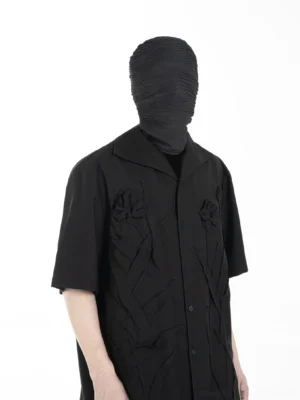 Three-quarter front view of a relaxed black camp collar shirt with raised floral and leaf appliques for Korean streetwear styling