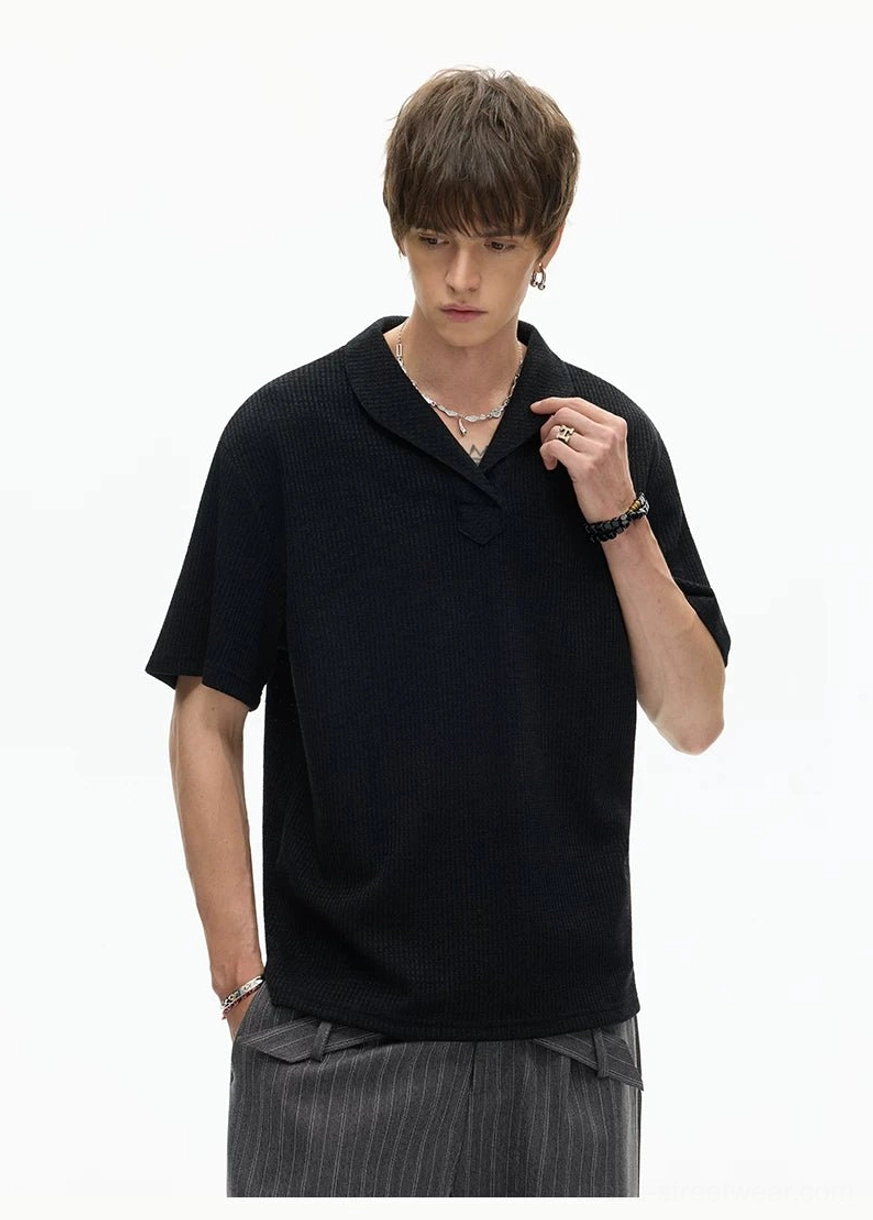 Black relaxed fit shawl collar knit polo tee with short sleeves and textured knit surface shown in a modern Korean streetwear outfit