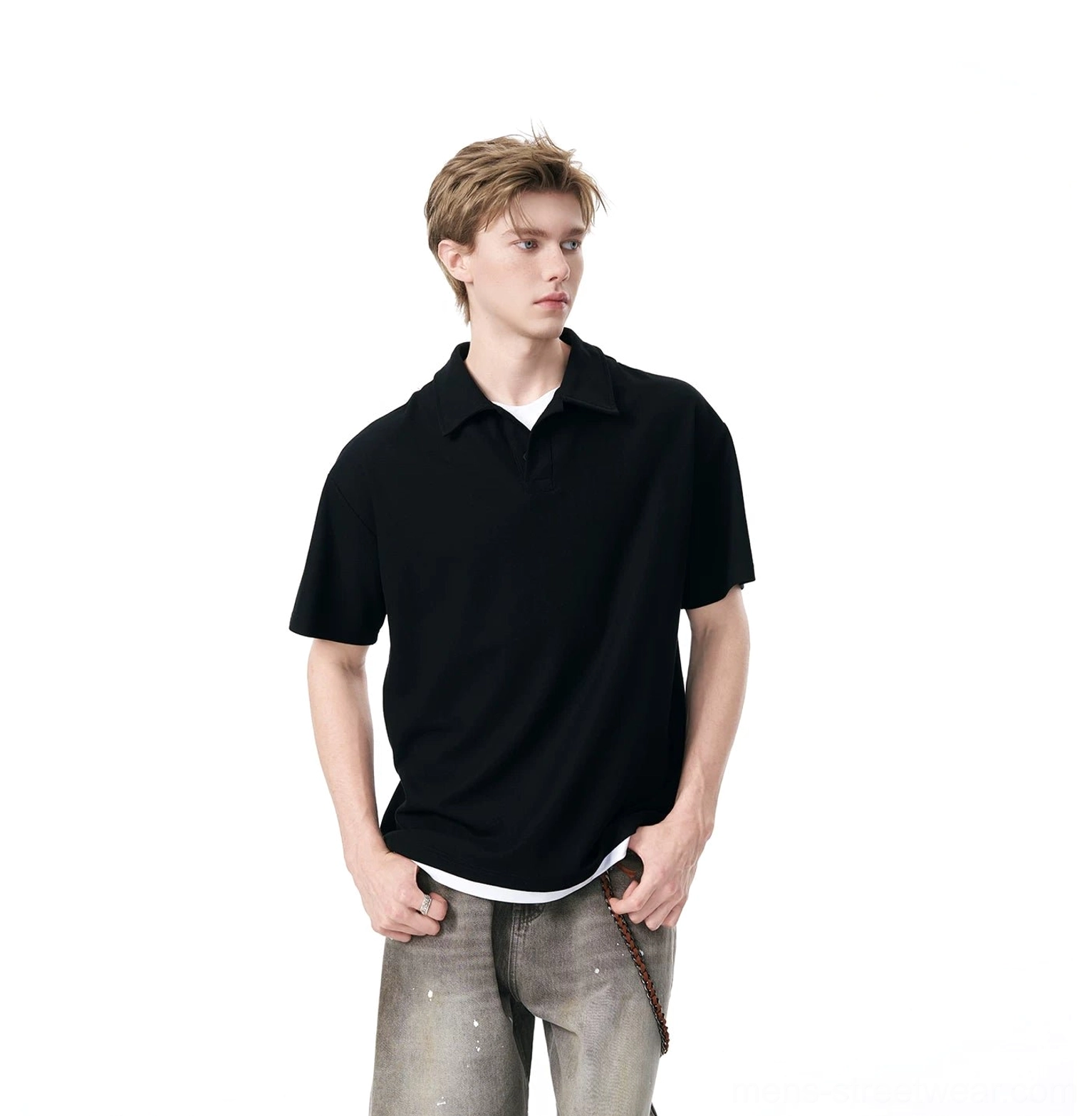 Black relaxed knit polo shirt styled with paint-splattered gray jeans for an urban streetwear outfit
