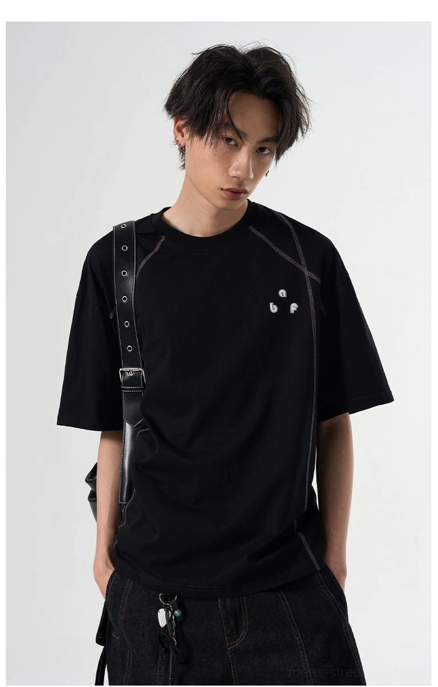 Black relaxed Korean streetwear T-shirt with subtle contrast stitching styled with hardware detail pants