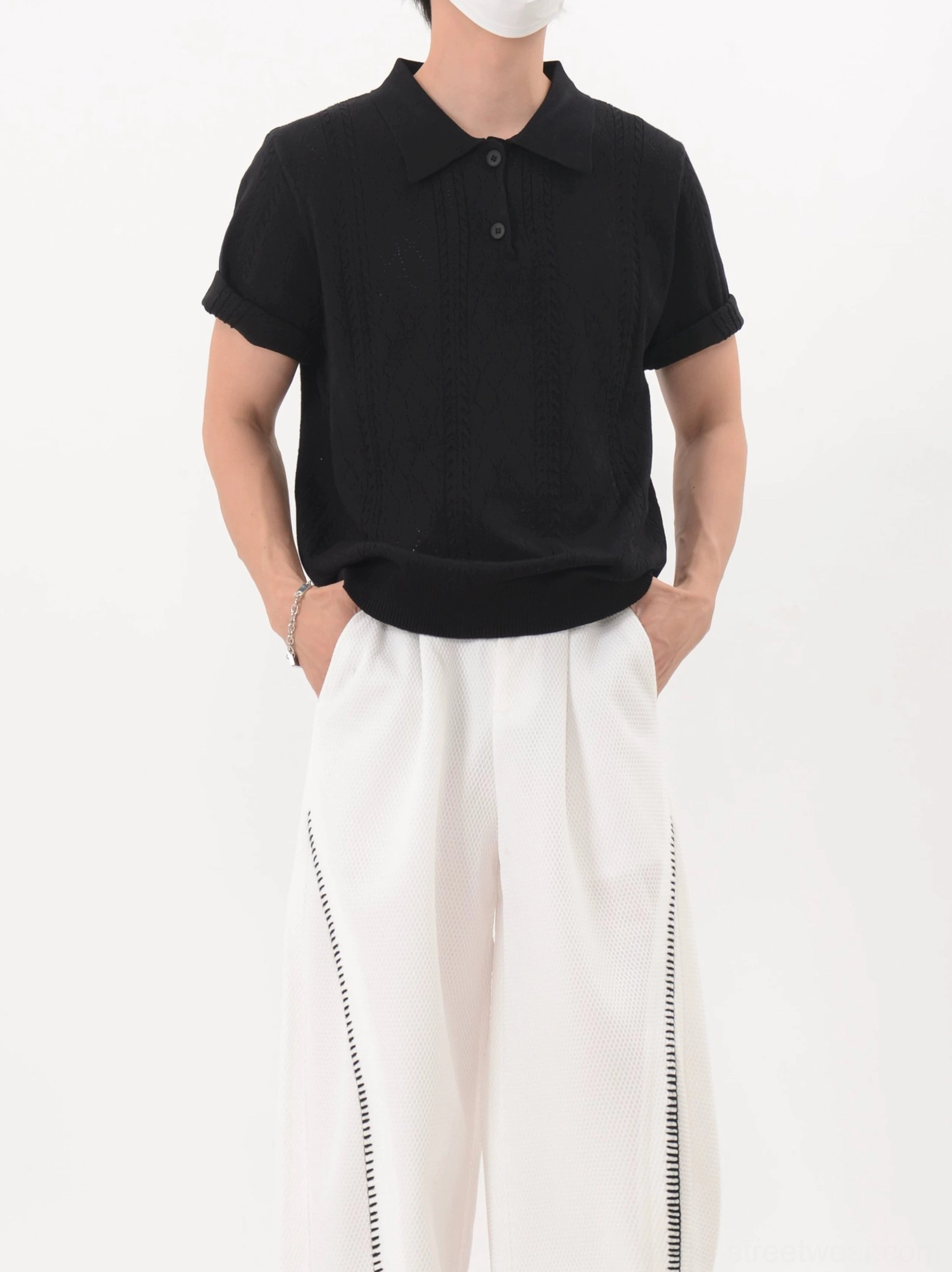 Black relaxed fit lattice knit polo shirt with subtle textured finish and rolled sleeves in minimalist Seoul streetwear outfit