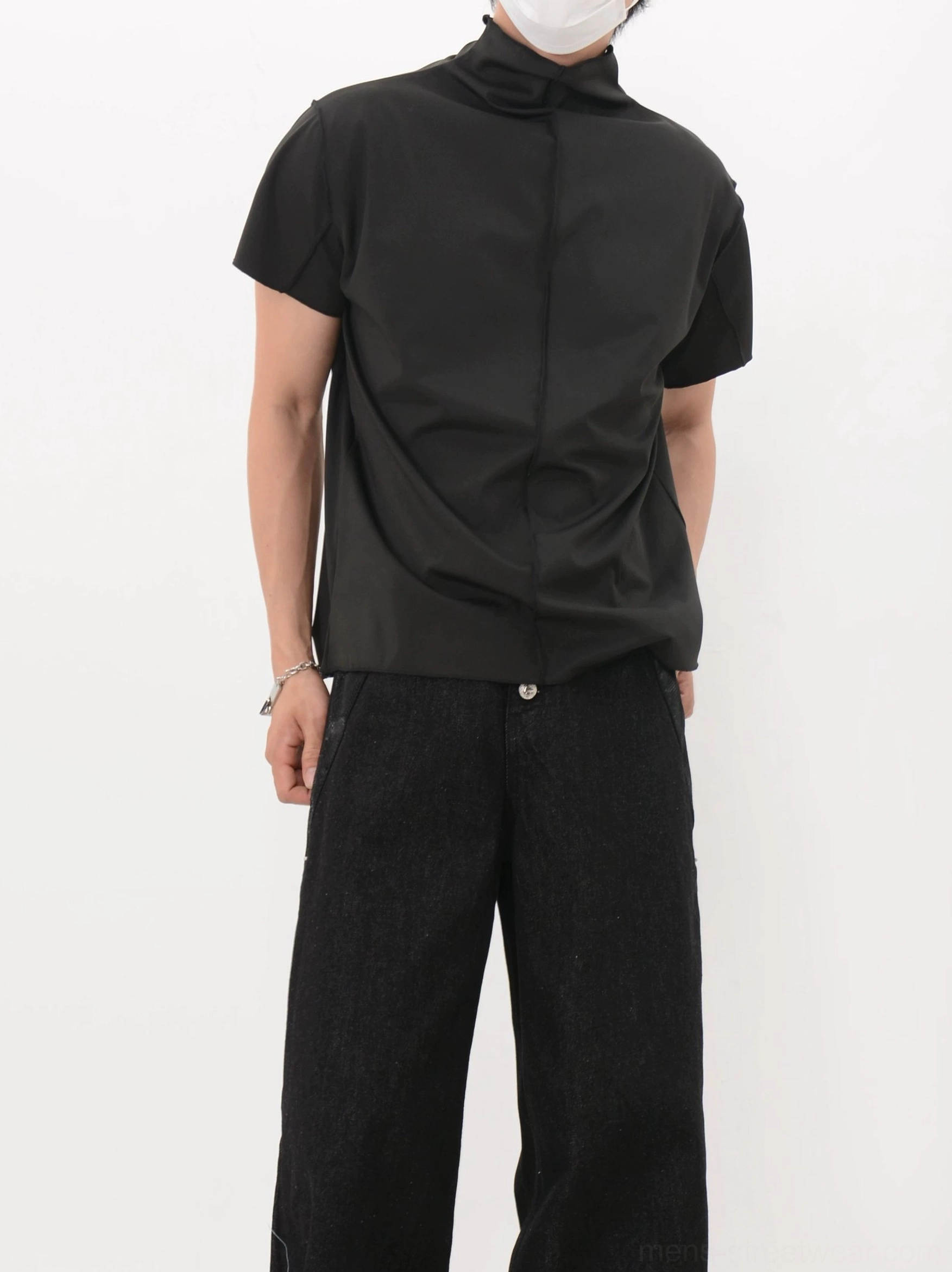 Front three-quarter view of a black relaxed mock neck shirt styled with wide-leg black denim for Seoul-inspired streetwear