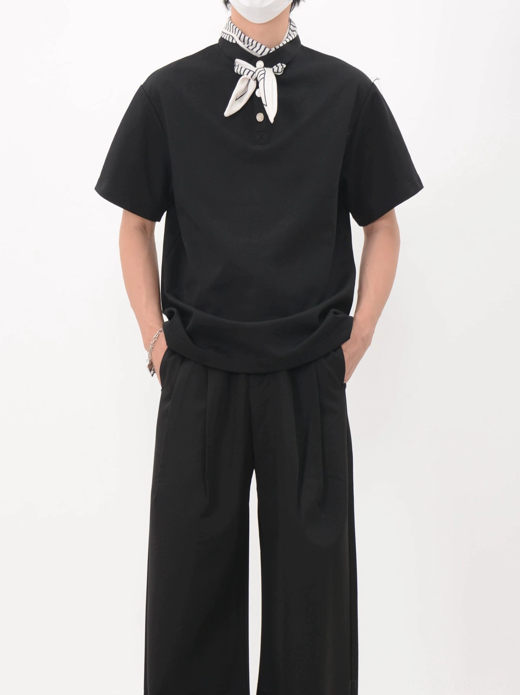 Black relaxed polo tee with neatly tied bandana collar detail shown from the front in contemporary Korean fashion styling