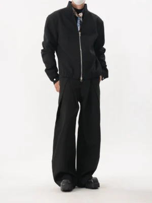 Black relaxed-fit stand collar blouson jacket back view showing gathered hem and streetwear silhouette