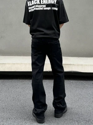 Black relaxed straight leg streetwear jeans rear view showing classic back pockets and full length draped denim silhouette