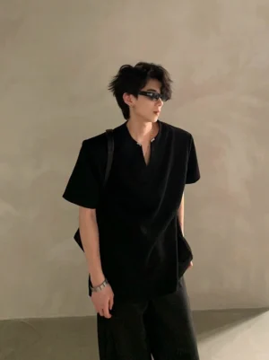 Black relaxed-fit V-notch neck short sleeve shirt shown on a male model with sunglasses in modern Seoul-inspired minimalist fashion styling