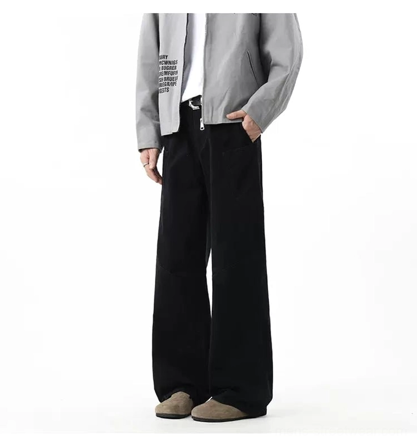 Black relaxed wide-leg cargo pants with minimal utility pockets styled with a light grey cropped jacket and suede loafers