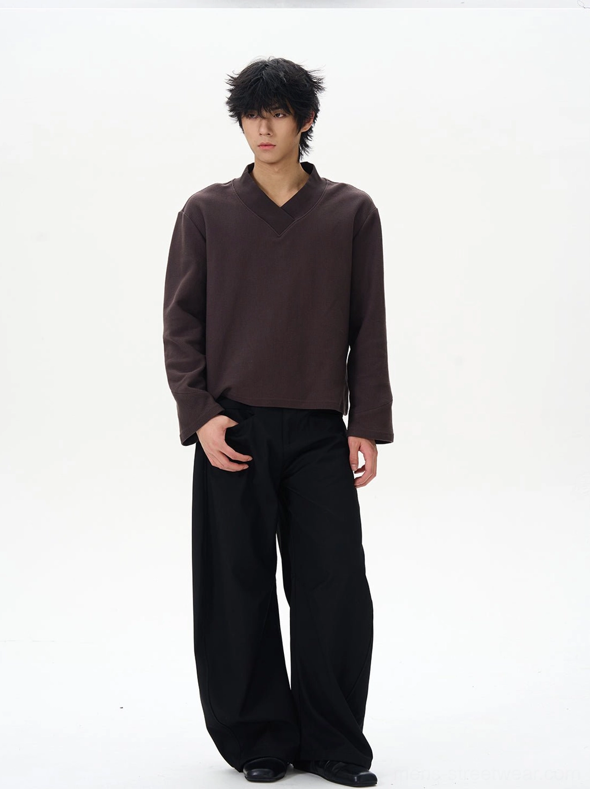 Black relaxed-fit wide-leg palazzo pants styled with a brown long-sleeve top for a minimalist East Asian streetwear outfit