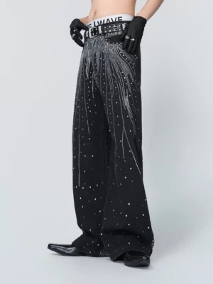 Front three-quarter view of jet black wide-leg denim jeans with waterfall rhinestone embellishments, silver studs, and contemporary Korean streetwear styling