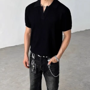 Black ribbed knit polo shirt with open Johnny collar and short sleeves styled with washed black jeans and chain wallet accessories