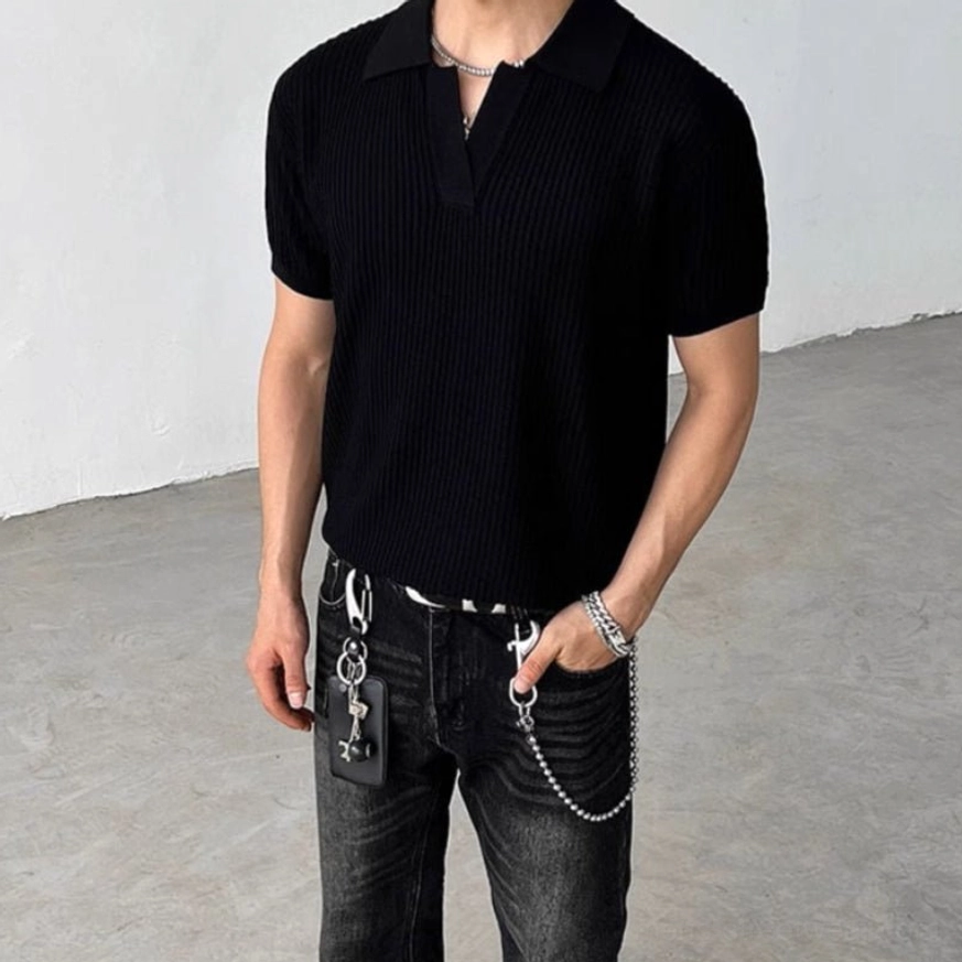 Black ribbed knit polo shirt with open Johnny collar and short sleeves styled with washed black jeans and chain wallet accessories