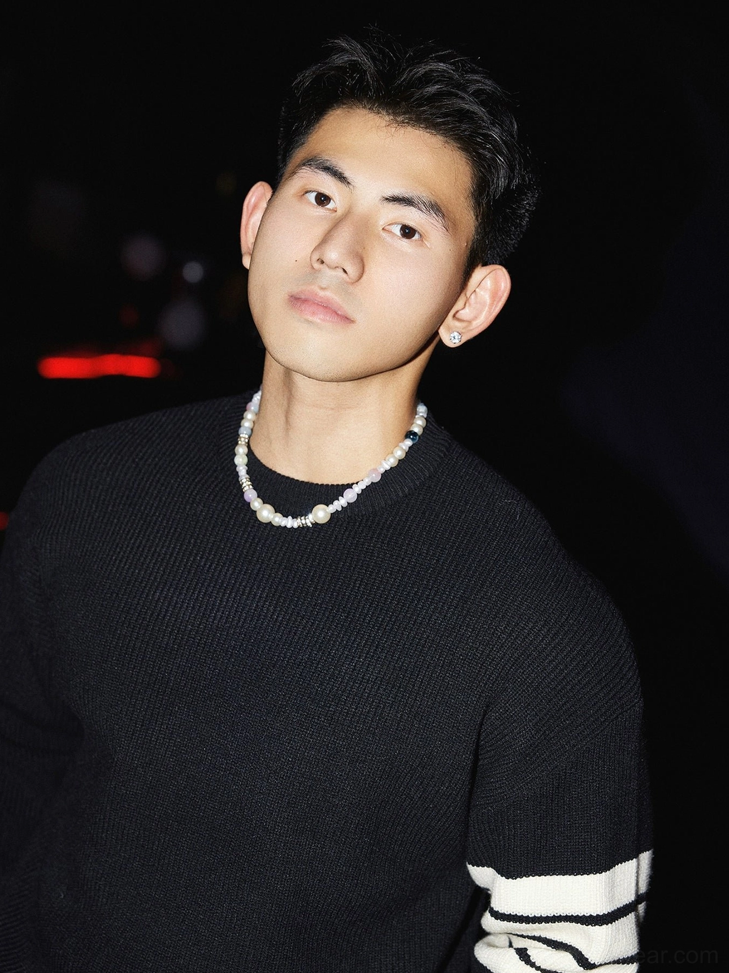 Close-up black ribbed knit crewneck sweater with contrasting white triple sleeve stripes and clean Korean streetwear design