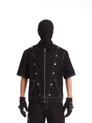 Black short sleeve rivet denim jacket with white contrast stitching and zip front worn with matching wide leg denim pants
