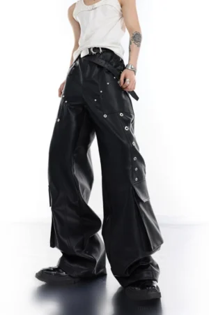Black PU leather cargo pants with metal eyelet rivets oversized wide-leg fit and leather belt front three-quarter view