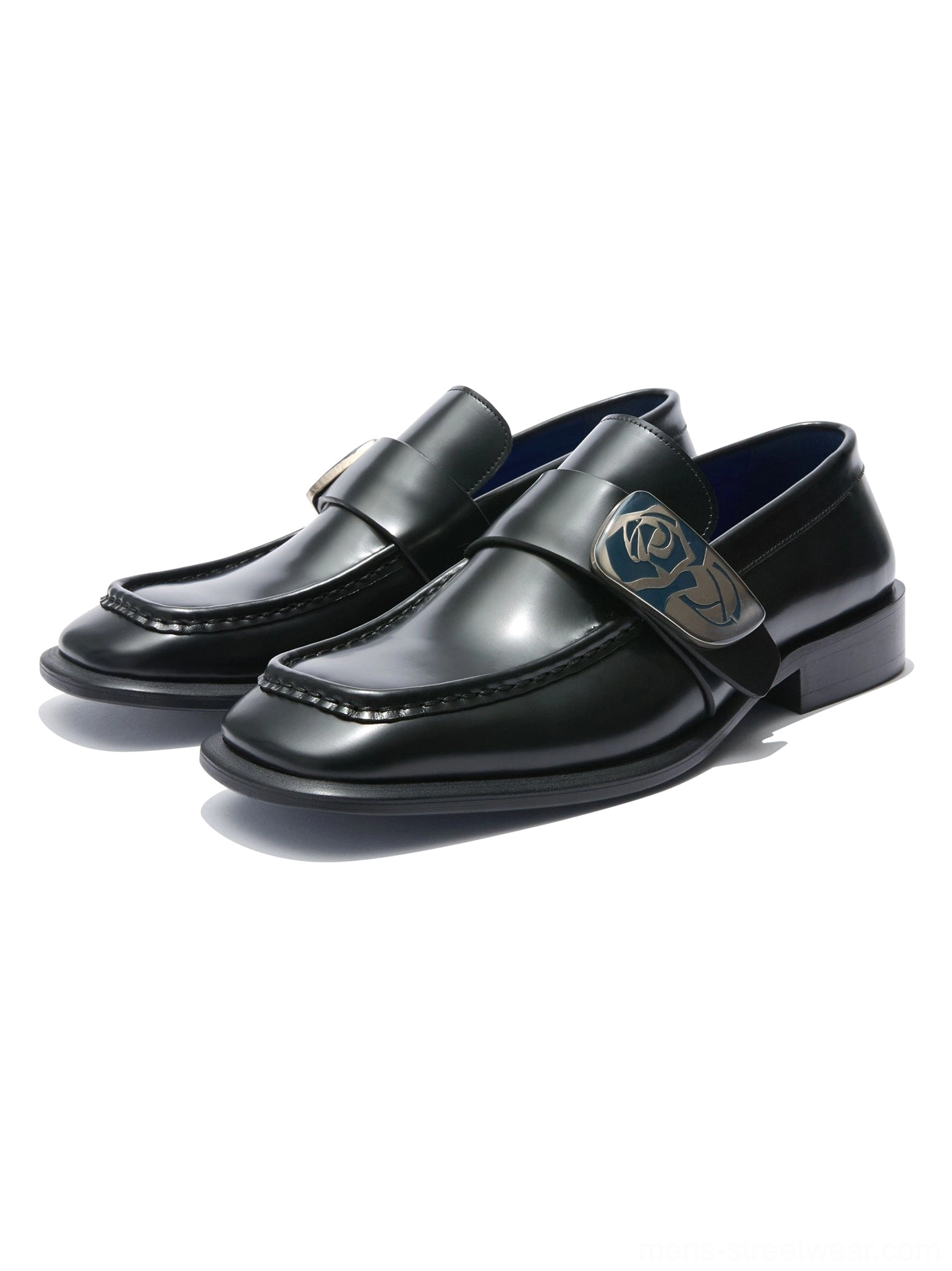 Polished black leather loafers with sculpted square toe rose crest hardware and vivid blue leather lining on a white background