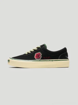 Black rose embroidered low-top skate shoes shown in left profile with contrast beige laces and an off-white vintage-tone rubber sole