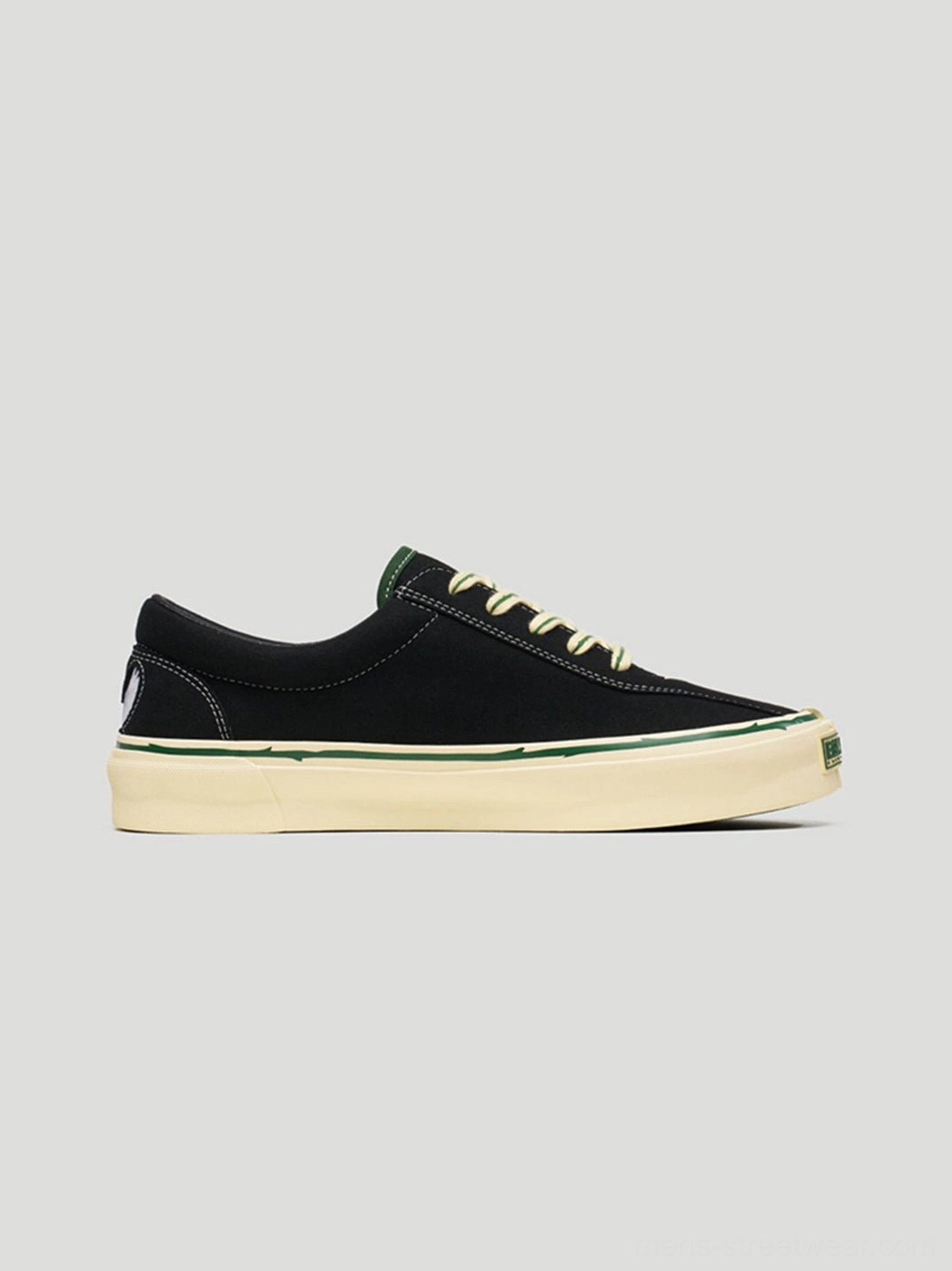 Close-up product view of black rose embroidered low-top skate shoes with contrast laces and textured upper