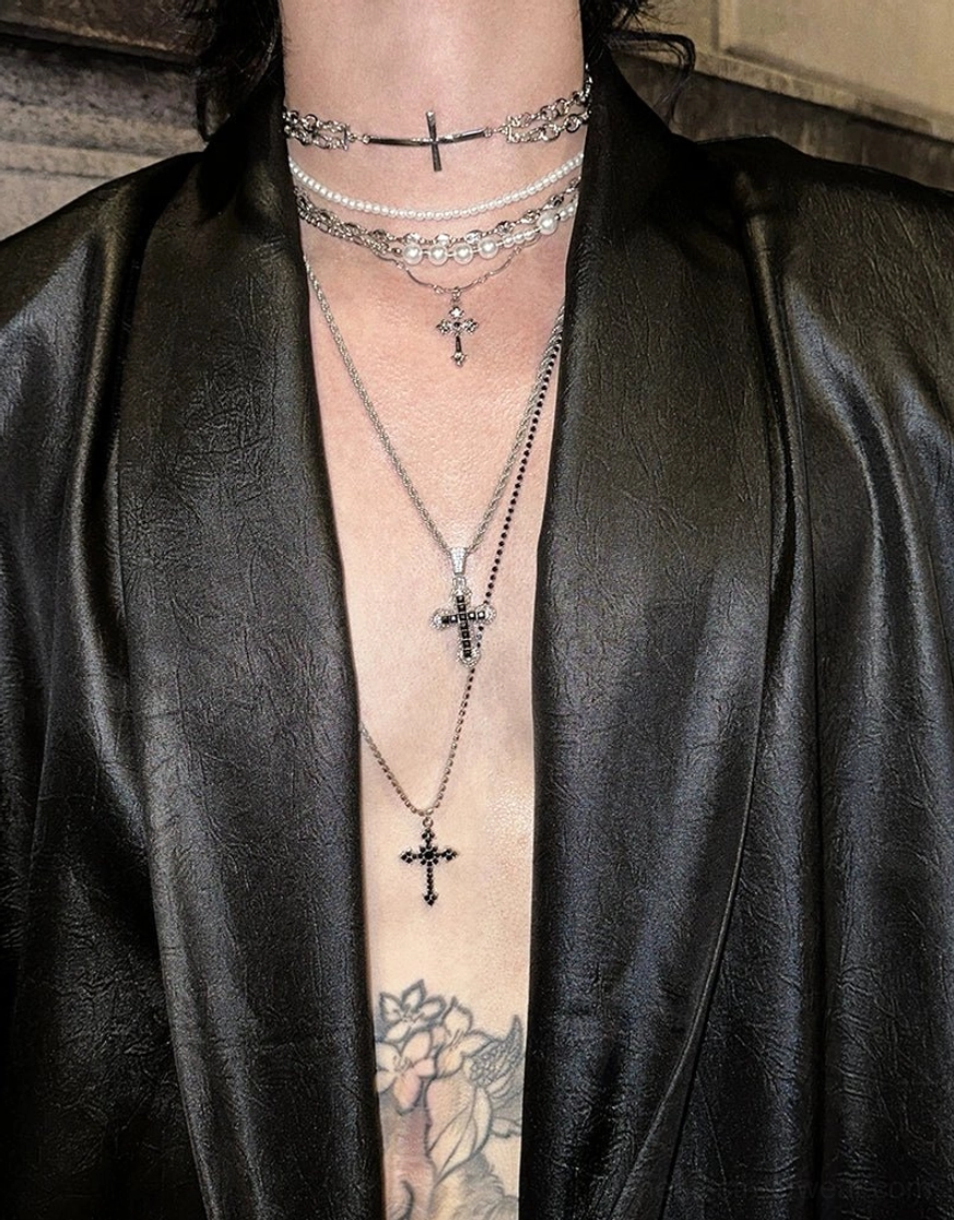 Close-up black satin shirt neckline with plunging shawl lapel and layered pendant necklaces