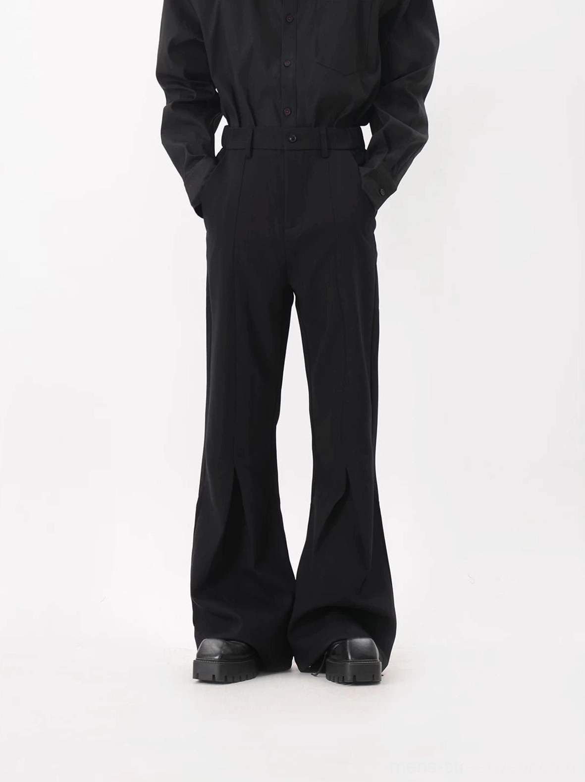 Black Korean streetwear flared trousers with dimensional front crease detail and platform shoe stacked hem
