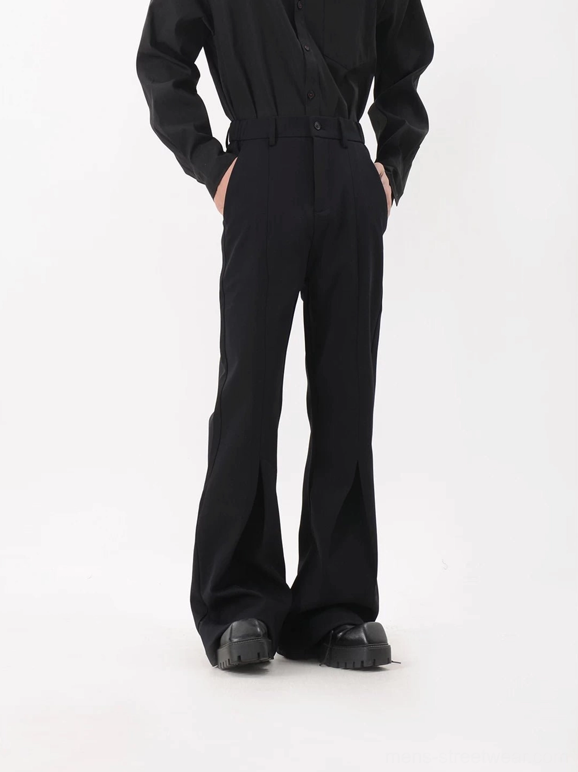 Black sculpted crease flared trousers front view with tailored mid-rise waist and wide flared legs