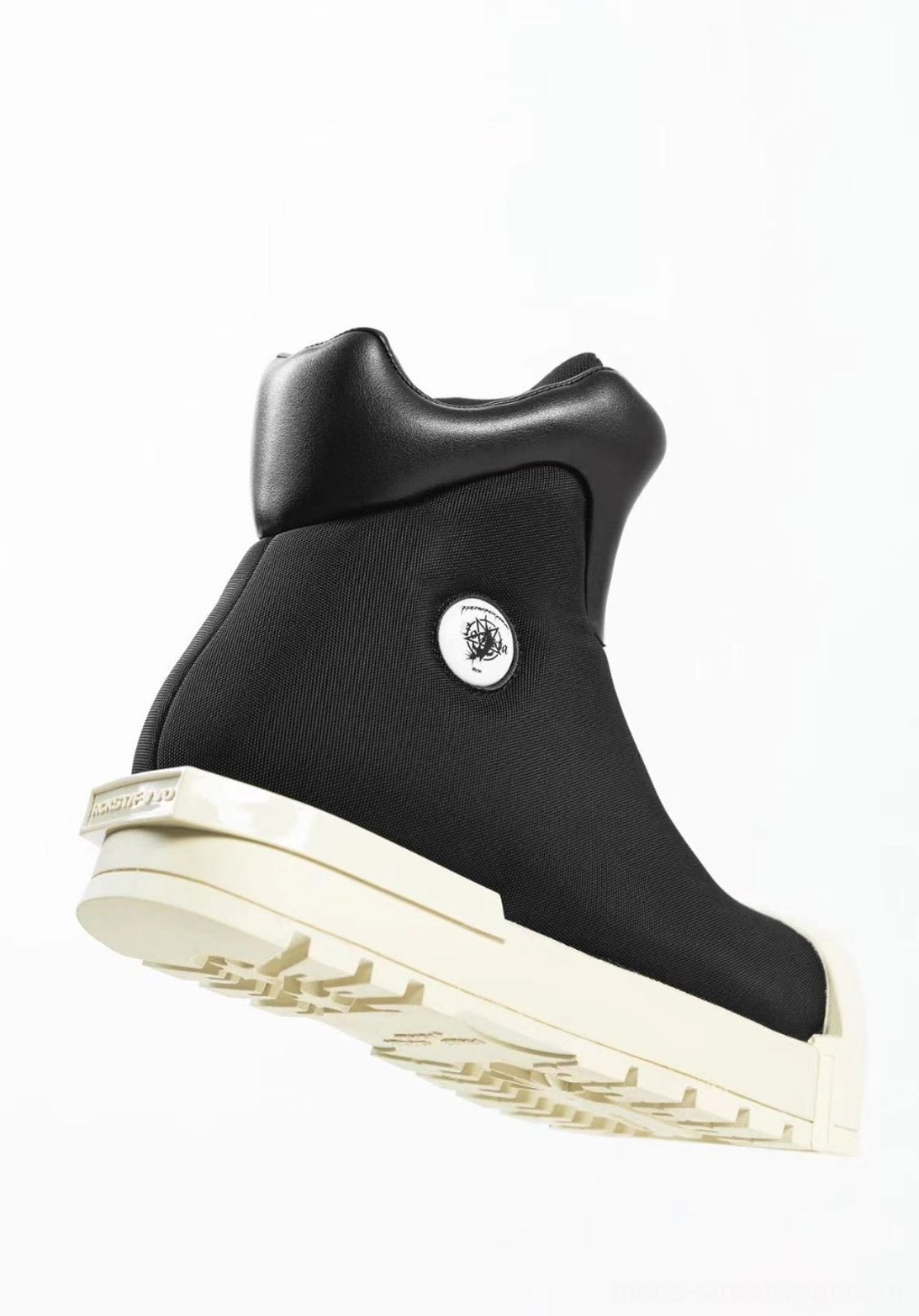 Black sculpted-toe platform high-top boot rear angle showing aggressive tread sole and padded high collar