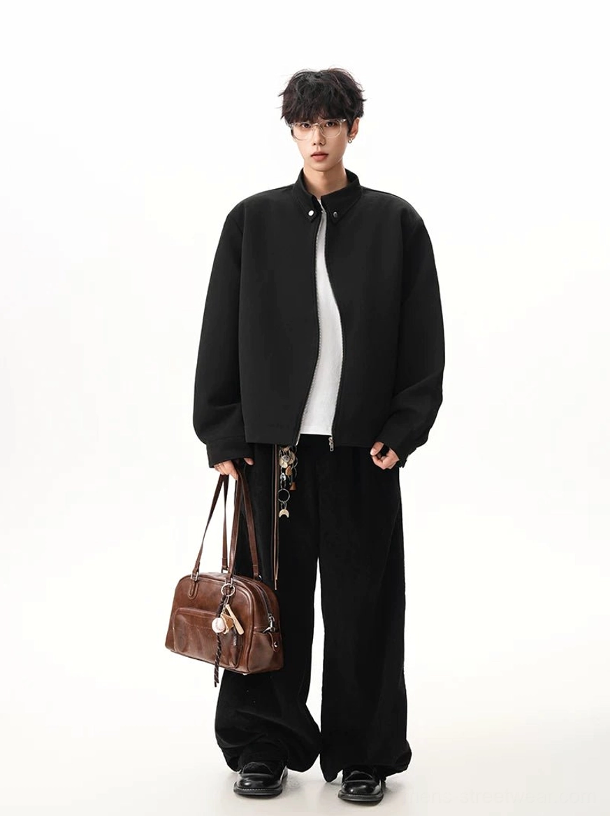Black Seoul streetwear stand collar zip jacket worn open with wide leg pants chain details and brown leather bag