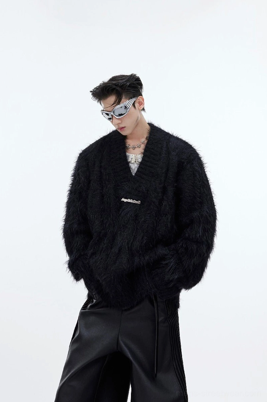 Black shaggy faux-fur V-neck sweater in an oversized Korean streetwear fit styled with silver sunglasses, layered necklace, and wide-leg leather pants