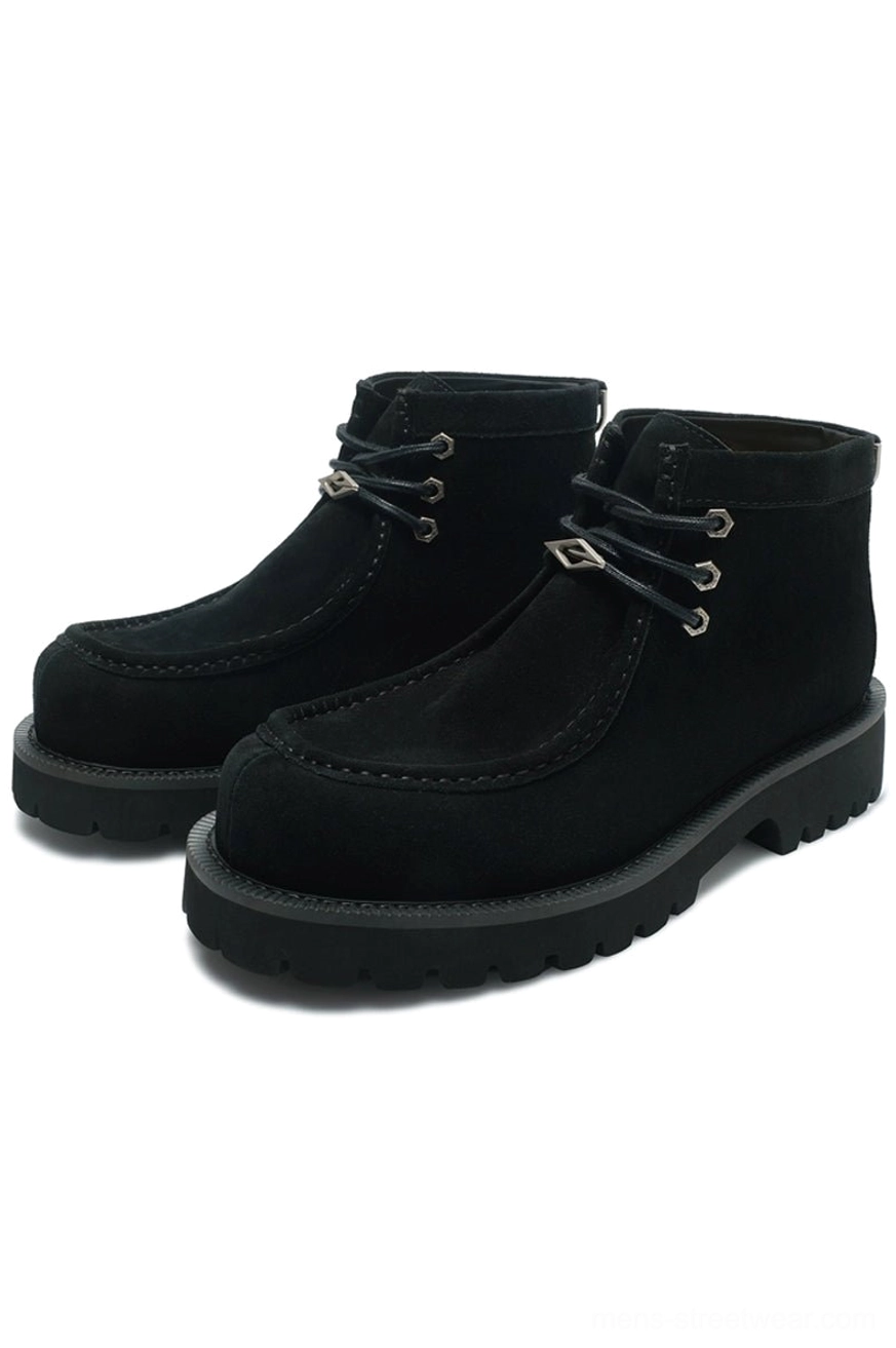 Black shearling moc toe lug boots featuring matte suede-look cowhide upper, metal eyelets, and chunky black rubber outsole