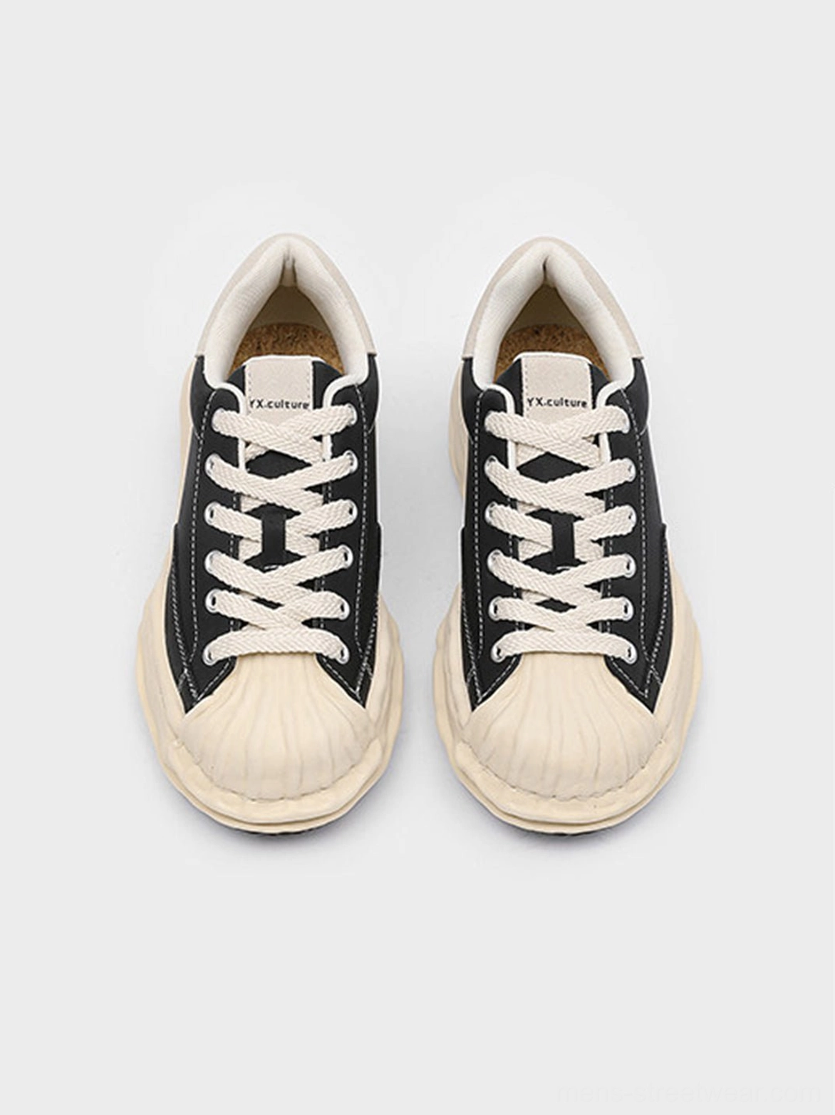 Black shell-toe platform sneakers with bold beige toe detail and elevated outsole for modern East Asian streetwear outfits